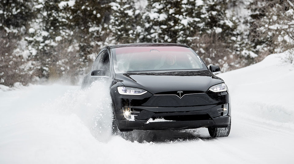 image of a tesla driving in snow